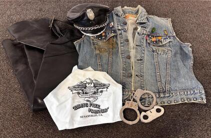 Denim Vest With Pins and Harley Davidson Patch On Back, Pair Of Leather Chaps, Hat, and Handcuffs with Key