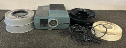(1) Saywer&rsquo;s Grand Prix 570R Slide Projector, (1) Kodak Carousel 80 Slide Tray, (2) Kodak Carousel Transvue 80 Slide Tray, And (1) Sawyers Rototray 100 Slide Tray