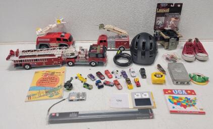 (14) Toy Cars Some Hot Wheels & Matchbox (1) Casio Exilim Digital Camera (1) Tile Tracking Devices, Box Is open. (3) Toy Fire Trucks (1) Rocky Marciano Figure (1) Red converse-style Shoes and More