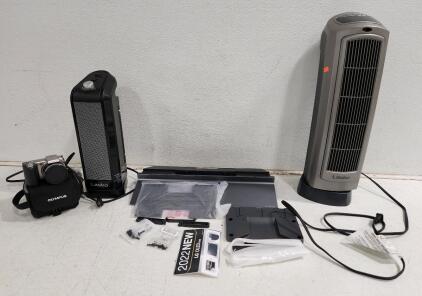 (1) LG Oled Evo 2022 TV Stand W/ Accessories (1) Olympus Digital Camera (1) 22" Lasko Ceramic Tower Heater with Digital Display (1) 16" Lasko Electric Oscillating Ceramic Tower Space Heater