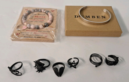 (8) Pieces Of Cosmetic Jewelry, (1) Rhodonite Bead Bracelet, (1) Stainless Steel Bracelet & (6) Black Finished, Fantasy Style Rings