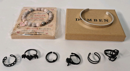 (8) Pieces Of Cosmetic Jewelry, (1) Rhodonite Bead Bracelet, (1) Stainless Steel Bracelet & (6) Black Finished, Fantasy Style Rings