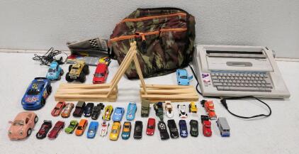 (1) Smith Corona Display Dictionary Typewriter (1) Wooden Toy Car Track (1) Diaper Dude Camo Messanger Bag And Assorted Toy Cars