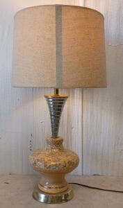 This is a Vintage 1950s Mid-Century Modern Atomic Table Lamp With a Ceramic Base and a Conical Chrome Neck.