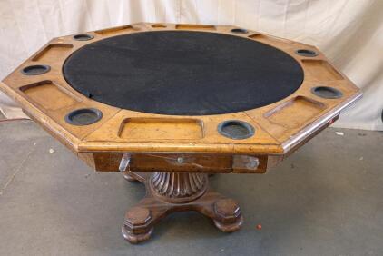 Octagonal Poker Table With a Reversible Top. It Has a Felt Playing Surface, Built-in Cup Colders, and a Pedestal Base.