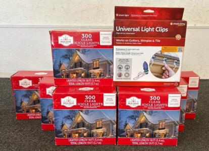 (7) Boxes Of Holiday Time 300 Clear Icicle Lights And (2) Box Of Unviseral Ligh Clips