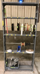 Metal Stand with Assortment of Rolled Tape, Wire and Hoses