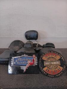 (6) Motorcycle Seats, (2) Harley Davidson Metallic Signs, And More.