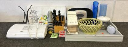 (1) FoodSaver, (1) The Food Lovers 21 Day Transformation Kit, (1) Toilet Paper Dispenser, And More