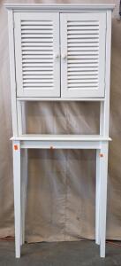 This is a White Over-The-Toilet Storage Cabinet with Louvered Doors. It Is Designed To Fit Over a Toilet to Maximize Vertical Storage Space In a Bathroom. 68"x27"x10"