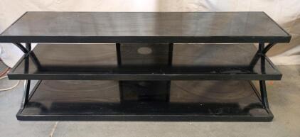 Black Glass Television Stand With a Black Metal Frame. It Has Three Glass Shelves and a Hole in the Back Panel for Cable Management. 60"x20"x16"