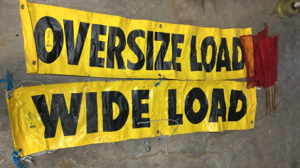 (OFFSITE) (2) 82&rdquo;L x18&rdquo;W Oversize/ Wide Load Banner (5) Red Caution Marker Flags