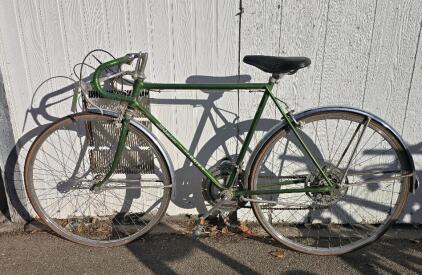 27" Green Vintage Schwinn Varsity bicycle, likely from the early to mid-1970s. The Schwinn Varsity was one of the company's "Electro-forged" bicycles, known for being mass-produced and durable. <br/>The bike in the image is a green, 10-speed