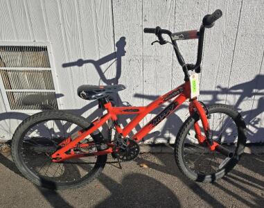 Orange Huffy Ignyte 20-inch BMX bike.