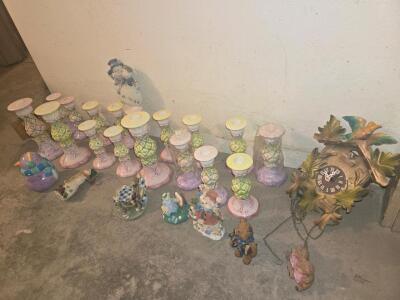 ( OFFSITE) Collection of ceramic decorative items, including a cuckoo clock, figurines, and a set of candle holders.