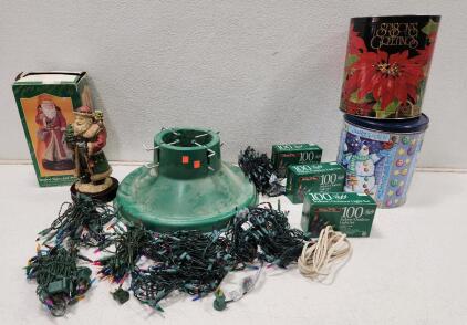 (1) J.C. Penney's "Red Coat Santa Claus" Musical Gigurine (1) Plastic Swivel Straight Christmas Tree Stand (8) Assorted Indoor Outdoor Holiday Lights (2) Holiday Themed Metal Tin Containers And Assorted Gift Wrapping Supplies