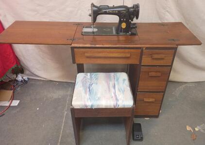 Vintage Singer Sewing Machine, Likely A Model From The 1960s or Earlier, Housed in a Wooden Cabinet With A Matching Stool.