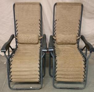[2]Zero-Gravity Outdoor Recliner Chair With a Beige or Tan Fabric and a Black Metal Frame.