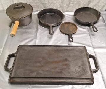 (5) Pieces Of Cast Iron, (1) 2Qt Pot W/Lid, (1) 9" x 16" Griddle, (2) 8" Pans & (1) 5" Egg Pan