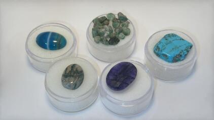 (1) 11.90ct. Natural Brazilian Rough Emeralds (1) 9.30ct. Blue Stripe Onyx (1) 7.30ct. Natural Moss Opal Oval (1) 16.75ct. Turquoise (1) 13.60ct. Tanzanite