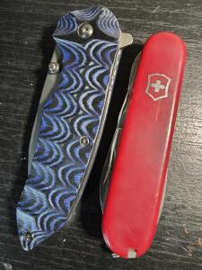 (1) Swiss Army Tool Folding Pocket Knife, (1) Unbrand Tactical folding pocket knife