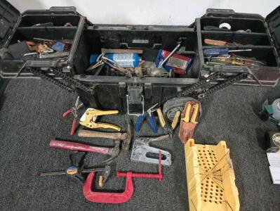 Rolling tool box with various tools and clamps.
