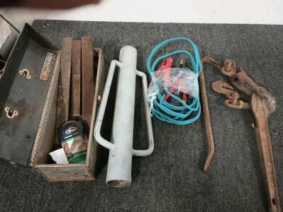Tool box with various files, post driver, ratcheting come along, crow bar and 10 foot long jumper cables.
