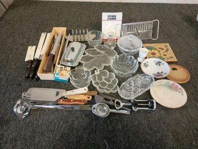 Assorted knives, small glass serving dishes assorted serving utensils.