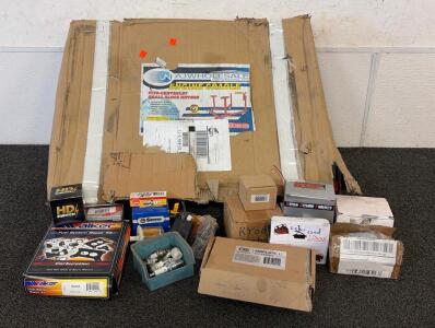 Various Car Parts Including (1) Engine Cradles (Missing 1 Caster), (1) Spark Plug, And More