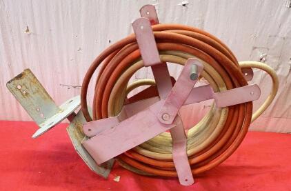 Wall-Mounted Hose Reel With a Hose.