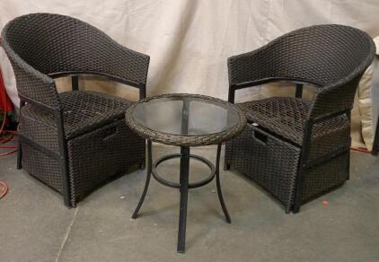 Black Three-Piece Outdoor Wicker Conversation Patio Bistro Set With Two Chairs And a Glass-Top Table. Chairs Come With Wicker Foot Rest Each. Chairs 32"x21"x23", Table 21"x20"x20"