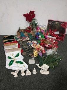 Christmas Decorations Ranging From Glass, Cloth, Pine Needles And Wood, (5) Everything Christmas Stockings, Beaded And Small Pinecone Garland, Metal Stars And Moon Wind Chime, White Creche Nativity Scene, Red Grape Cluster Lights