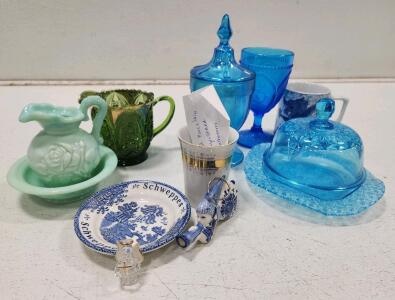 (1) Fenton Celeste Blue Stretch Glass Covered Candy Dish (1) Vintage Blue Ornate Depression Glass Goblet (1) Vintage Northwood Green Glass Creamer (1) Mosser Glass Queen's Pattern Covered Butter Dish And Assorted Glassware
