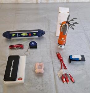 (1) 5000mAh Power Bank, (1) Pair Of Earbuds, (1) Multi USB Charger Cable, (1) 2-GB Flash Drive, (1) Emergency Flashlight Multi-Tool, (1) Pocket Knife, (1) Pocket Tape Measure & (1) Pocket Level