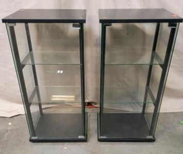 [2] Glass Display Cabinet With A Black Frame With 2 Interior Glass Shelves. 17"x15"x34"