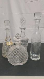 Elegant Crystal Decanter Set with Faceted Stoppers and Floral Designs