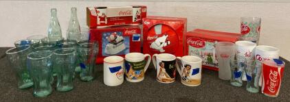 Variety Of Collectible CocaCola Glasses, Mugs, Figurine, And Volleyball