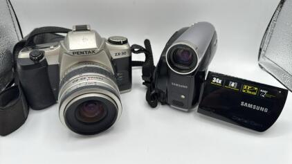 (1) Pentax ZX-30 35mm SLR Film Camera With A 35-80mm Lens. (1) Samsung SC-D382 MiniDV Camcorder.
