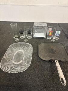 (8) Assorted Glasses, (1) Storage Container, (1) Glass Serving Platter, (1) Cast Iron Fry Pan