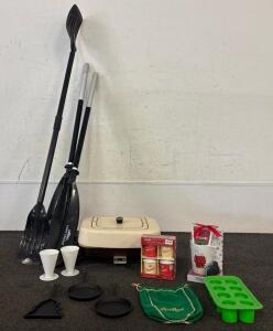 (1) Presto Deluxe Nonstick Griddle, (3) Unbranded Mini Cast Iron Skillet Pans, (2) Unbranded Ice Cream Cups, (1) Holiday Coco Mixer 4 pack, (1) Peanuts Hot Coco And Mug Gift Set, (1) Crown Royal Bag, (1) Silicone Ice Mold, (2) Lost Creek Boat Paddles, (1)
