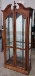 Brown Wooden Curio Cabinet with Glass Shelves and Ornate Top Design