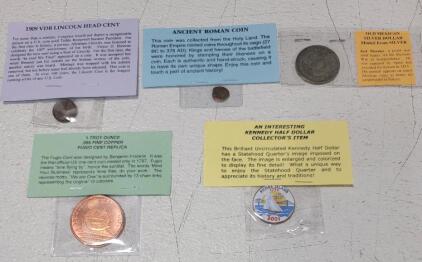 (1) 1999 VBD Lincoln Head Cent, (1) Ancient Roman Coin (1) Old Mexican Silver Dollar (1) 1 Troy Ounce .999 Fine Copper Fugio Cent Replica (1) 2001-D "Rhode Island" Statehood Commemorative Quarter with Painted Obverse