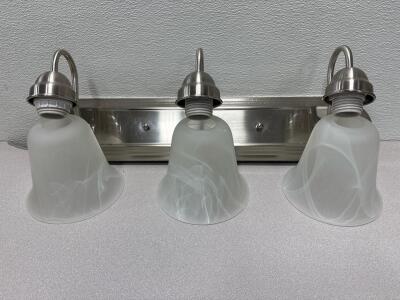 Three-Light Vanity in a satin steel finish with alabaster glass.