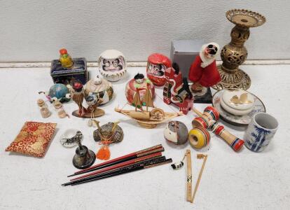 (1) Miniature Cast Iron Japanese Samurai Kabuto Helmet (1) Vintage Japanese Folk Craft Doll (1) Vintage Ornate Brass Pillar Candle Holder And Assorted Vintage Japanese Souvenirs