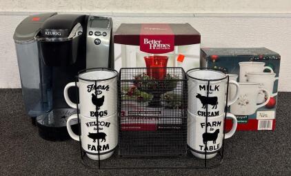 Home Goods Lot (1) Keurig (1) Better Homes And Garden Hurricane Pedestal Candle Set (1) 4 Piece Christmas Mug Set (1) 4 Piece Farmhouse Mug Set