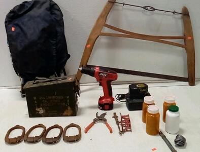 Antique Wooden Buck Saw. Skil Power Drill (9.6 Volt. Battery Included. Unable To Test.) Ammo Can. Child's Hard Frame Backpack. (4) Bottles Of Lead.Dewault Battery & Charger. + More.