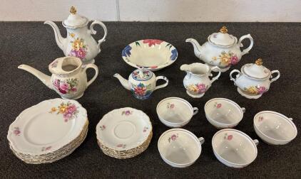 Elegant 21+Piece Porcelain Tea Set, Floral Design with Gold Trim and more. Approx. dimensions of teapot: 10" height, cups: 2" height, 3.5" diameter, saucers: 5.5" diameter, plates: 7.5" diameter