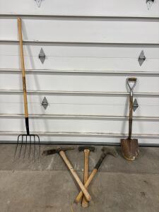 Various Tools Including A Pitchfork And A Shovel And More.