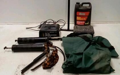 Pelican 1120 Case. 5' Water Shutoff Key. Schumaker Battery Charger (Unable To Test.) AW32 Hydraulic Oil (Unopened.)Dutch Harbor Gear Rubber Coveralls. Tie Strap.