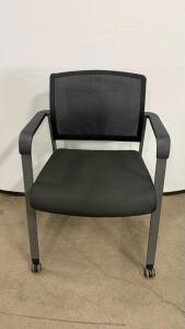 Black Office Chair with Mesh Back, Fixed Armrests, and Caster Wheels